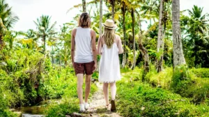 Pasangan berjalan di area sawah Bali untuk bulan madu romantis.